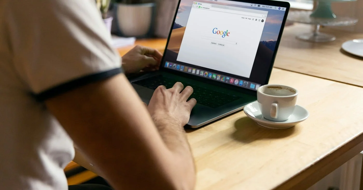Person searching Google on a laptop